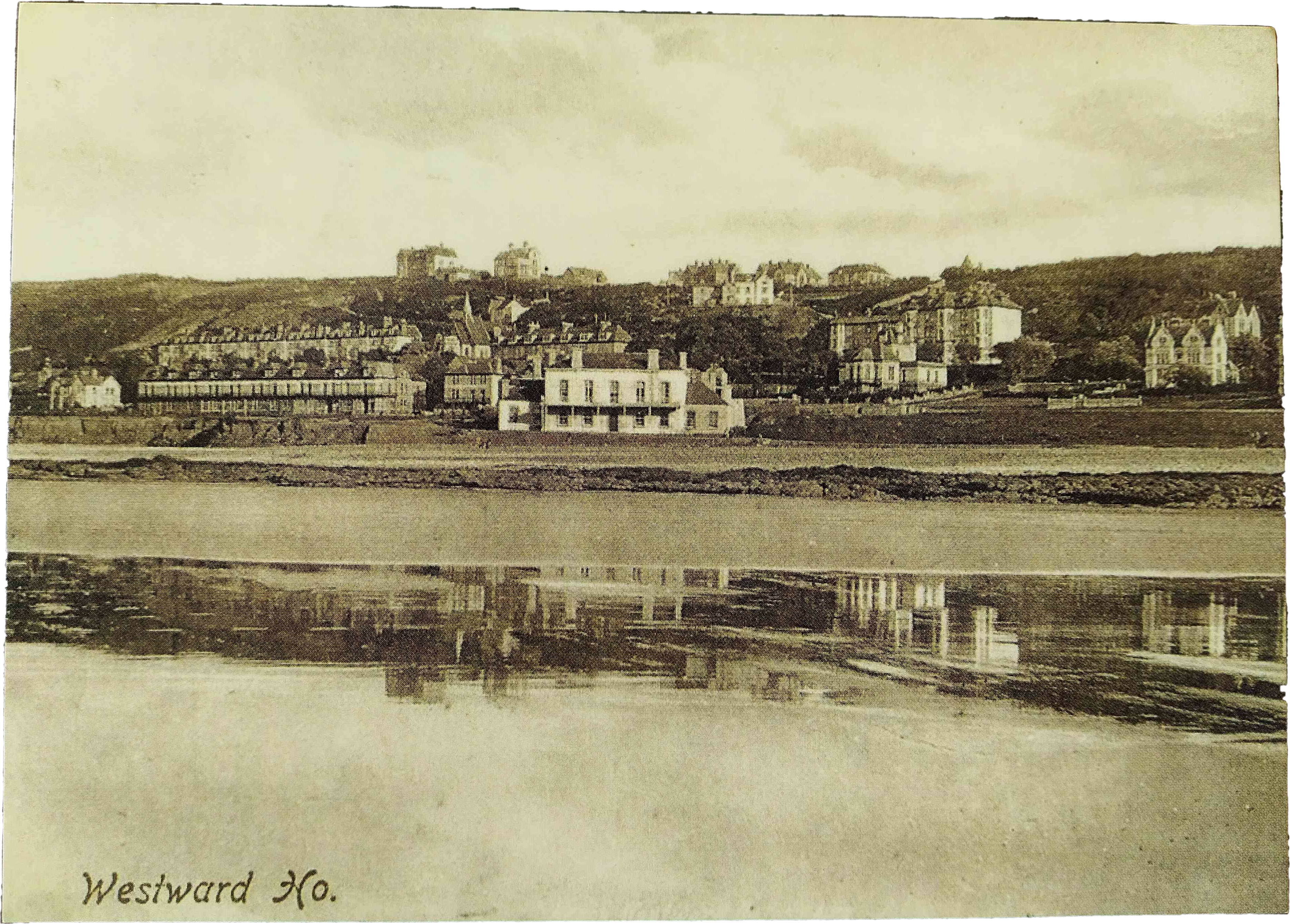 An old black and white photograph of a seafront as viewed from out to sea